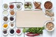 Spices and dried vegetables with cutting board on white planks