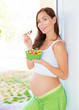Pregnant female eating salad