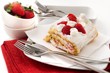 Roll sponge cake with whipped cream and strawberries