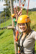 Woman with helmet smiling in adventure park