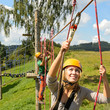 People with ropes in adventure park