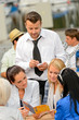 Women customers ordering from waiter at restaurant