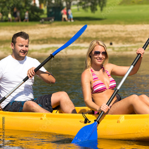 Photo: Couple sitting in kayak on a sunny day Couple sitting in kayak on a sunny day