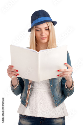 Photo: Young woman reading womens magazine Young woman reading womens magazine