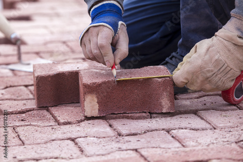 Photo: marking with a pencil on a brick paver, before CUTTING marking with a pencil on a brick paver, before CUTTING