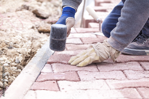Photo: Paver bricks settings by rubber hammer Paver bricks settings by rubber hammer
