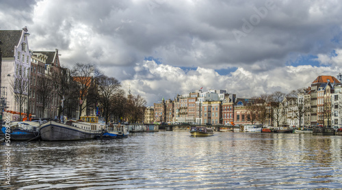 Photo: view of the two banks of the river Amstel, Amsterdam downtown view of the two banks of the river Amstel, Amsterdam downtown