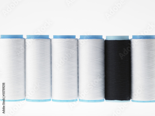 Photo: White on white, spools of thread on white background White on white, spools of thread on white background