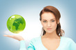 woman holding green globe on her hand