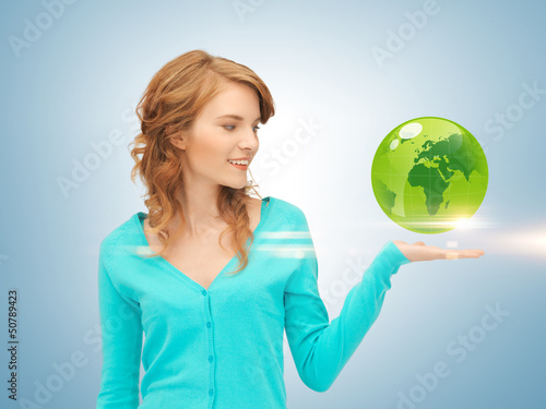 Photo: woman holding green globe on her hand woman holding green globe on her hand