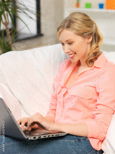 Photo: woman with laptop typing at home woman with laptop typing at home