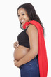 Photo: Portrait of happy young pregnant woman wearing superhero cape over white background Portrait of happy young pregnant woman wearing superhero cape over white background