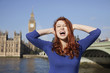 Photo: Angry young woman with hands on head screaming against Big Ben clock tower, London, UK Angry young woman with hands on head screaming against Big Ben clock tower, London, UK