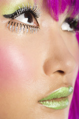 Photo: Extreme close-up of young funky woman's face with false eyelashes and green lipstick Extreme close-up of young funky woman's face with false eyelashes and green lipstick