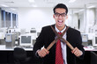 Businessman cutting his neck with a scissor