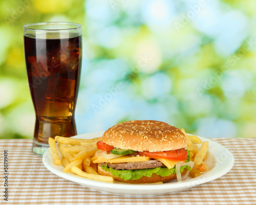 Photo: Tasty cheeseburger with fried potatoes and cold drink, Tasty cheeseburger with fried potatoes and cold drink,