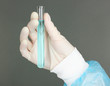 Glass tube with fluid in scientist hand during medical test
