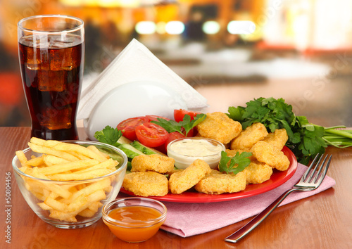 Photo: Fried chicken nuggets with vegetables,cola,french fries and Fried chicken nuggets with vegetables,cola,french fries and