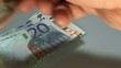 hand of a banker who has a lot of money in euro banknotes