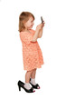 Little girl looking in the mirror. Side view.