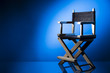 Photo: Director chair on a dramatic lit background Director chair on a dramatic lit background