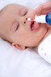 woman hand cleans baby's nose