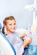 Girl cleaning toy dentures