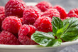 Closeup of fresh raspberries with mint leaf