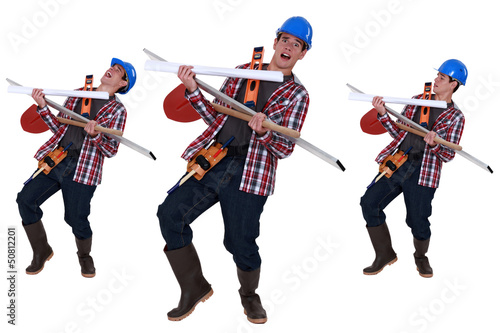Photo: Handyman struggling to carry tools Handyman struggling to carry tools