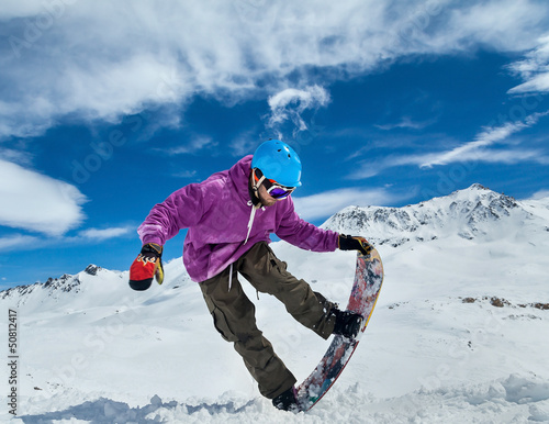 Photo: Snowboarder in mountains Snowboarder in mountains