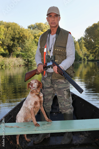 Photo: Hunter with dog on boat Hunter with dog on boat