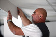 Tradesman installing drywall