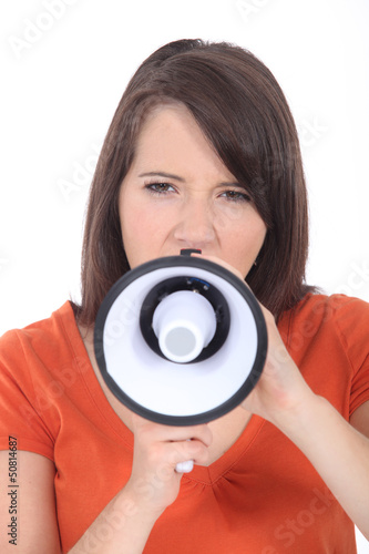 Photo: Brunette woman speaking into megaphone Brunette woman speaking into megaphone