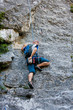 Man practices in climbing at the rock in the Crimea mountains