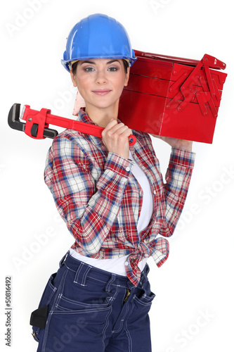 Photo: A female manual worker with a toolbox and a wrench. A female manual worker with a toolbox and a wrench.