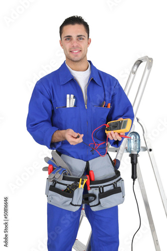 Photo: Handyman holding a multimeter Handyman holding a multimeter