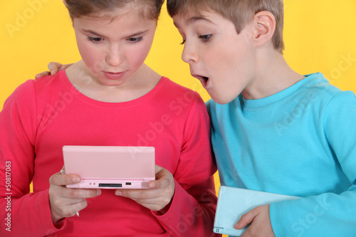 Photo: Two children playing video games Two children playing video games