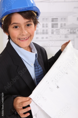 Photo: Little boy imitating architect Little boy imitating architect