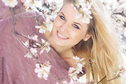 Photo: beautiful blonde girl in spring cherry garden beautiful blonde girl in spring cherry garden