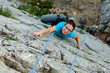 Woman practices in climbing at the rock in the Crimea mountains
