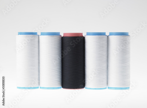 Photo: White on white, spools of thread on white background White on white, spools of thread on white background