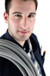 Tradesman carrying corrugated tubing around his shoulder