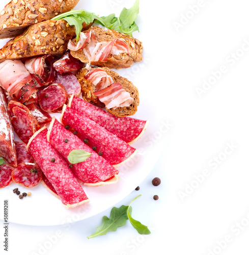 Photo: Sausage. Italian Ham, Salami and Bacon isolated on White Sausage. Italian Ham, Salami and Bacon isolated on White