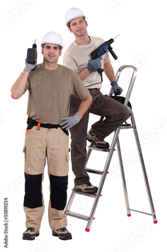 Photo: craftsmen working with a drill craftsmen working with a drill
