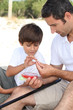 Father teaching his young son to fish