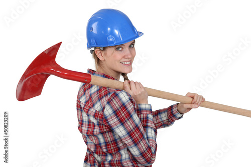 Photo: Woman carrying spade Woman carrying spade