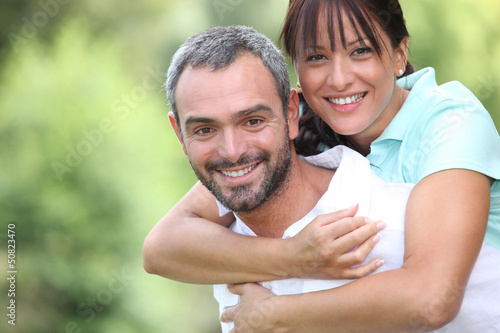 Photo: Playful couple in park Playful couple in park