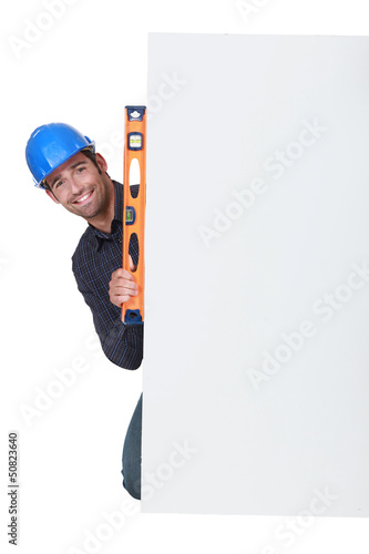 Photo: Workman with a spirit level Workman with a spirit level