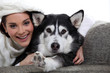 Woman with her dog on a sofa