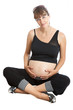 A pregnant woman (9 months) sitting and holding her tummy